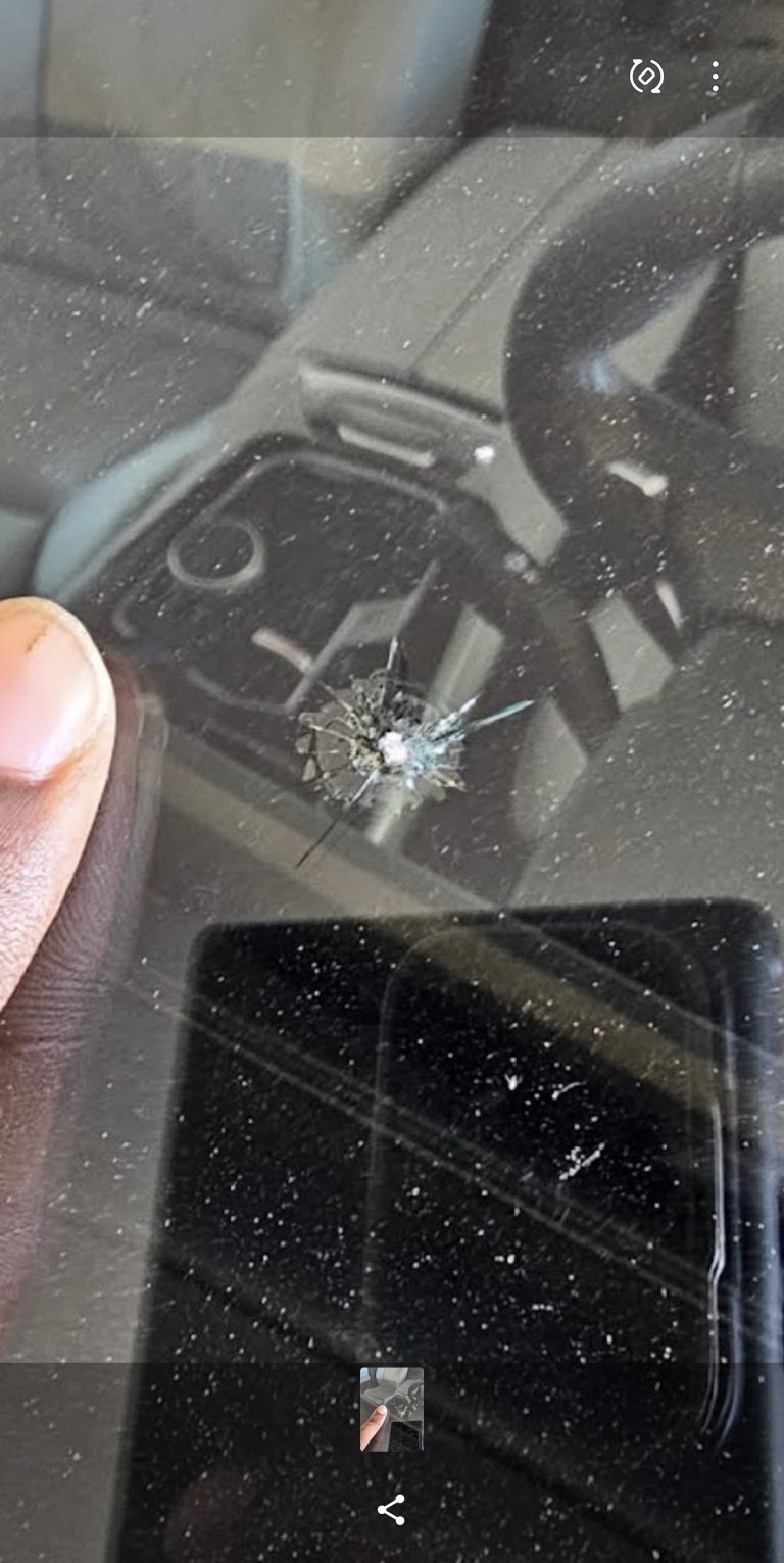 Close detail of the chip repair tool against windshield glass